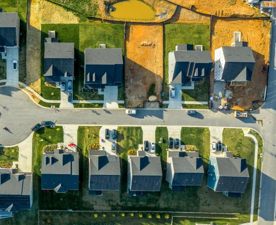 Overhead view of a neighborhood with new lots being prepared for a new home