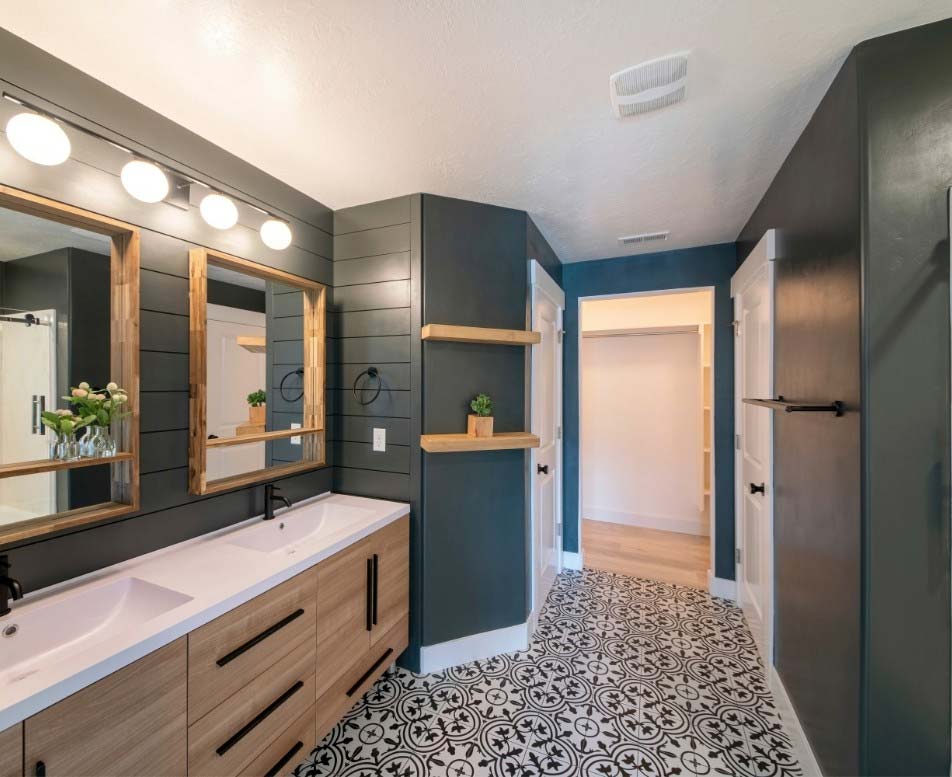 Dark walls, double sinks, interesting tile floor featured in a bathroom remodel