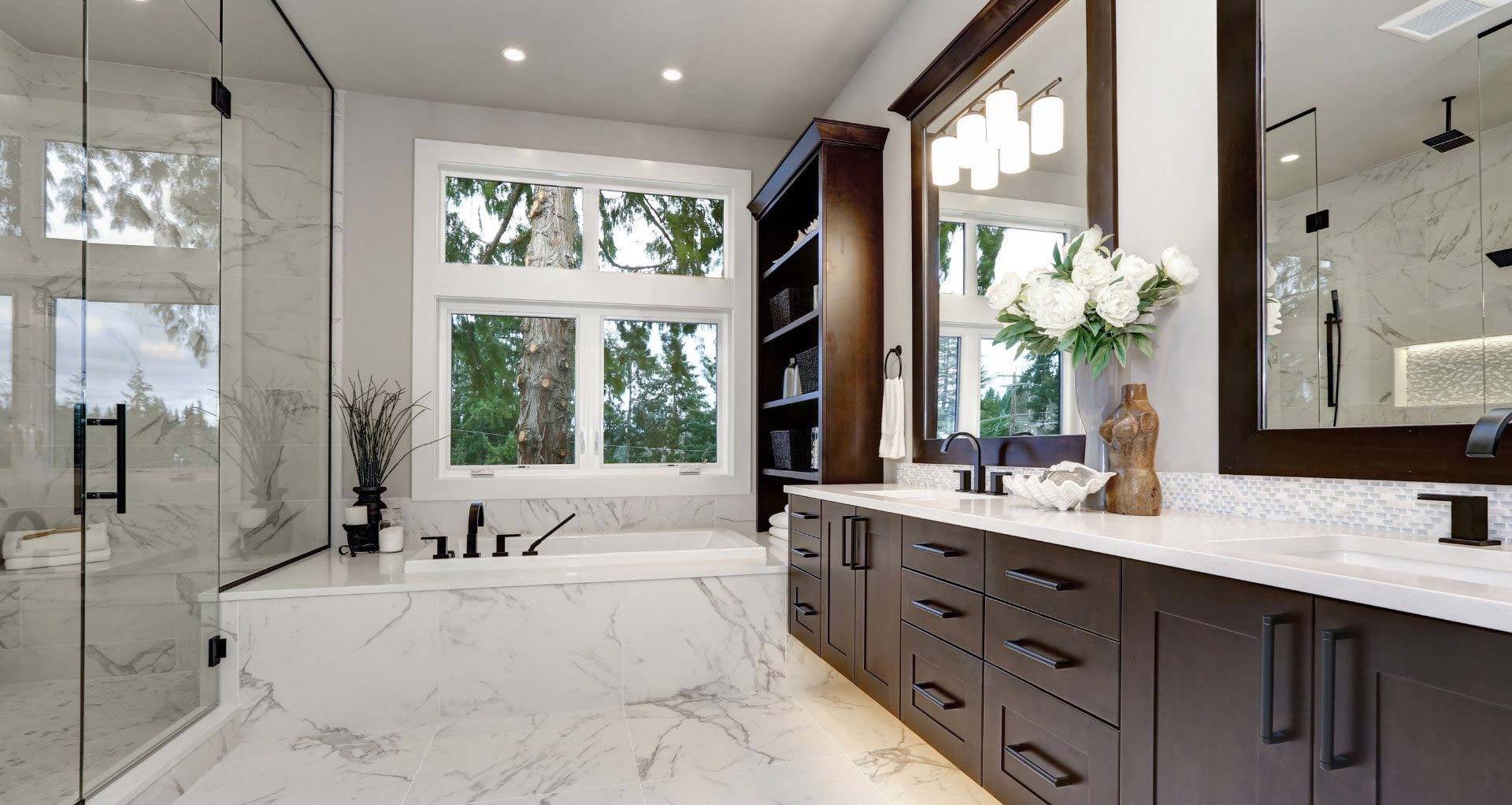 Marble flooring bathroom remodel with large bathtub and walk-in shower