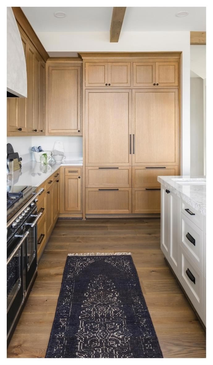 Wood cabinets paired with white island cabinets