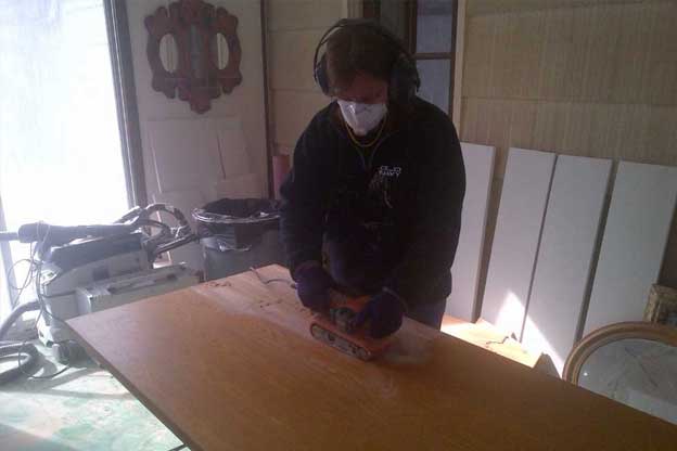 Mom sanding and refinishing butcher block