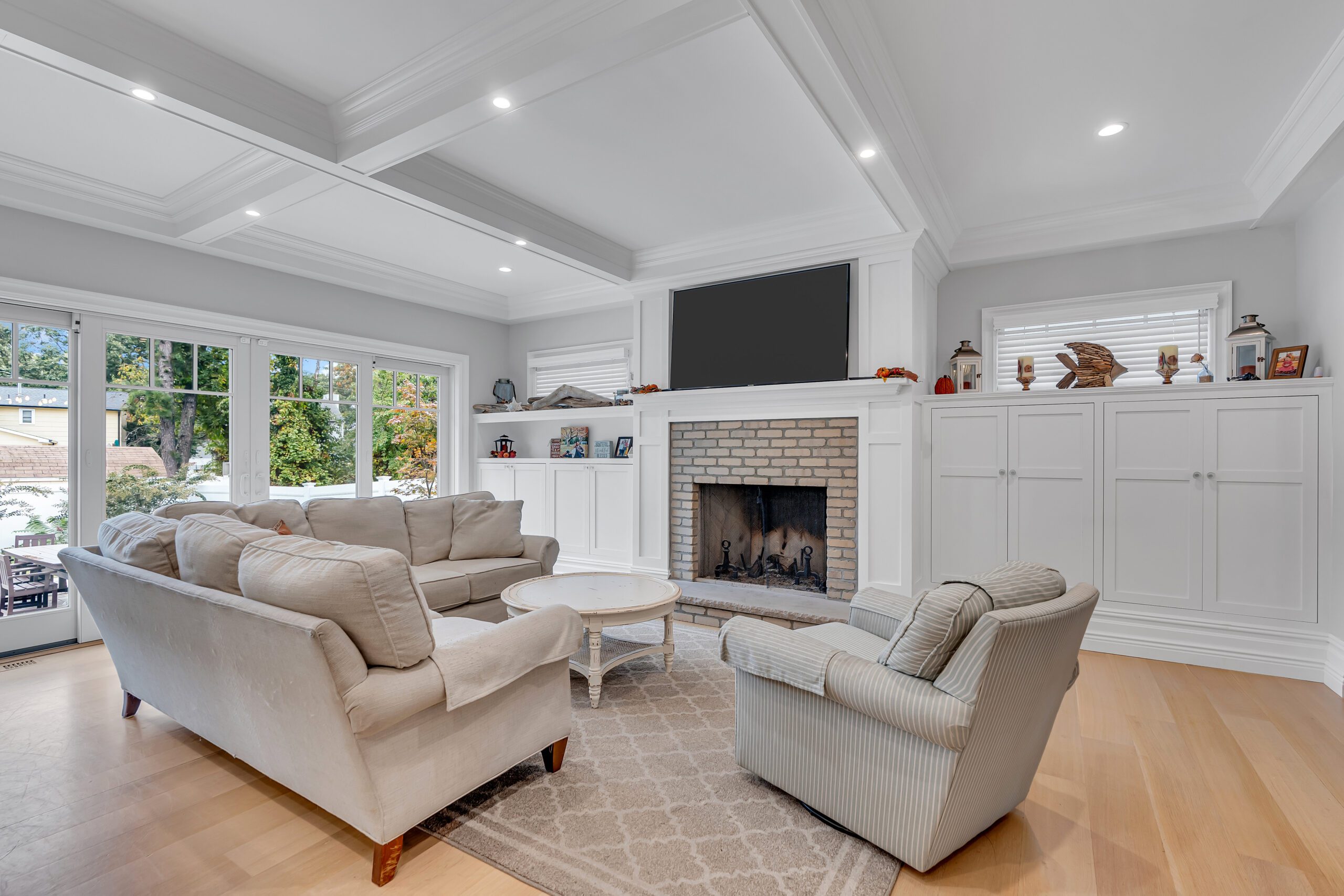 Living room home addition with coffered ceiling