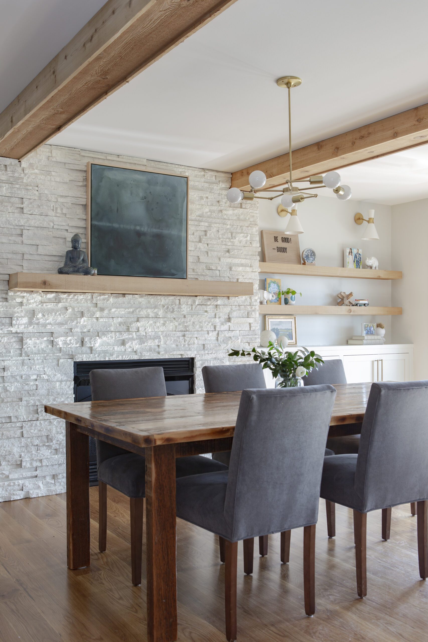Dining room home addition with raw material finishes including white stone and warm wood