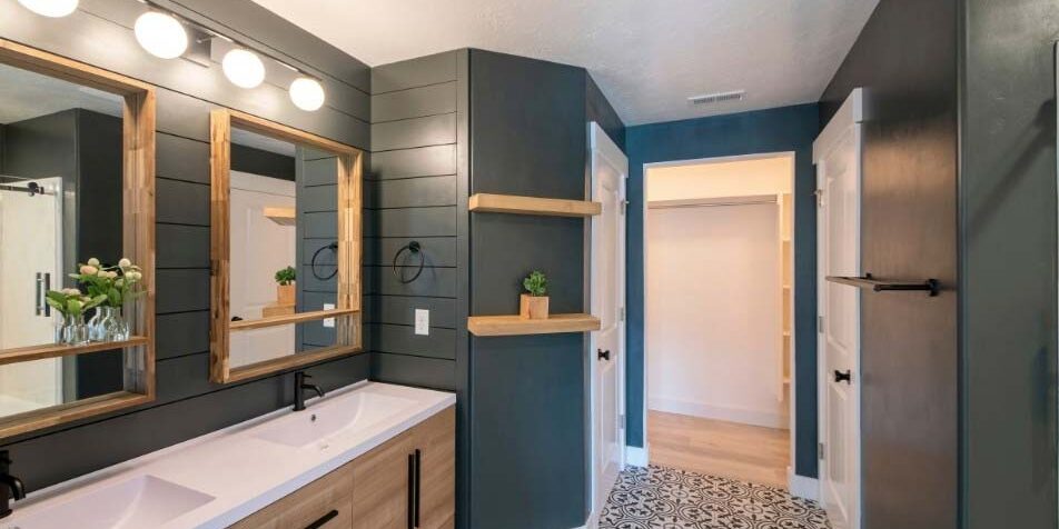 Dark walls, double sinks, interesting tile floor featured in a bathroom remodel
