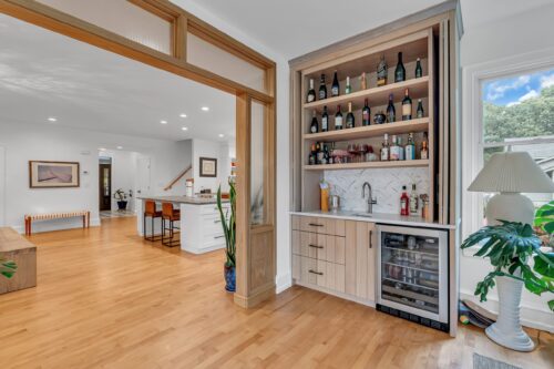 Brick, NJ remodel showing open living space and custom wine rack
